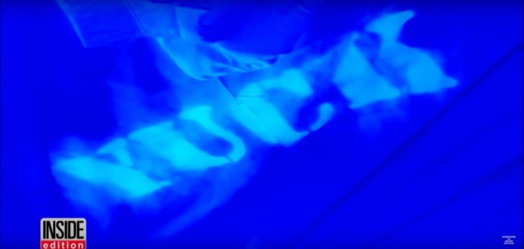 Image of the word Yuck under blacklight, dirty hotel sheets.