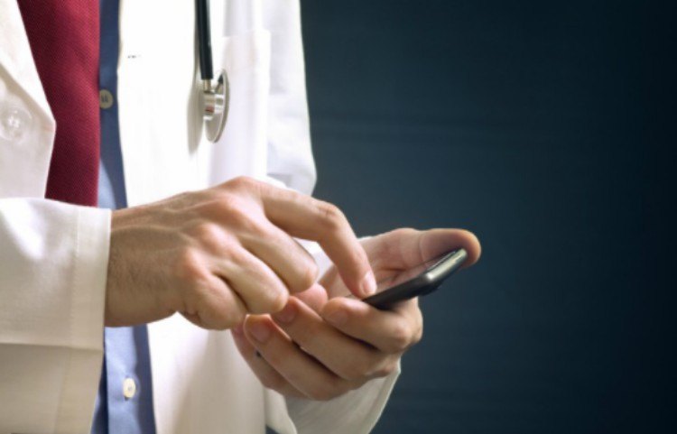 doctor looking down at smartphone