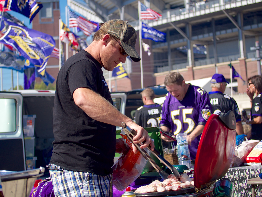 Man grilling at tailgate party.