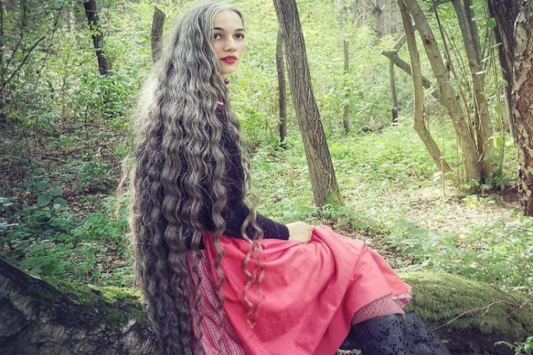 Shot of woman in forest long gray hair.