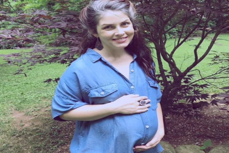 Pregnant woman with gray hair.